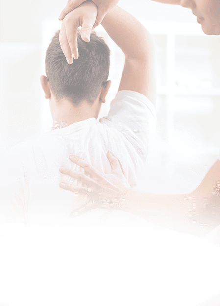 A physical therapist providing shoulder and back pain assessment and treatment for sports injury recovery, emphasizing expert sports medicine care.