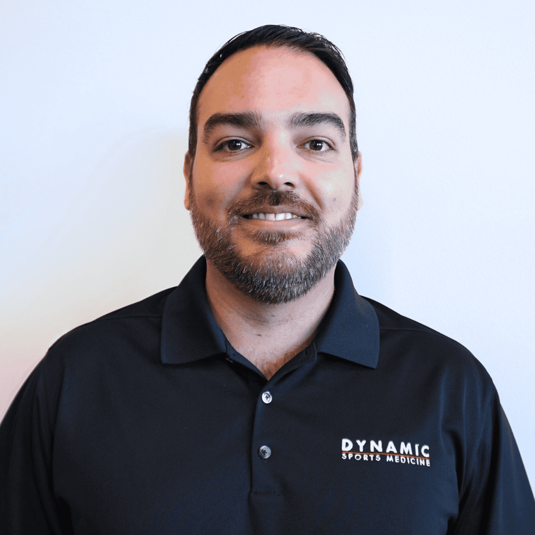 Physician in sports medicine uniform, smiling.