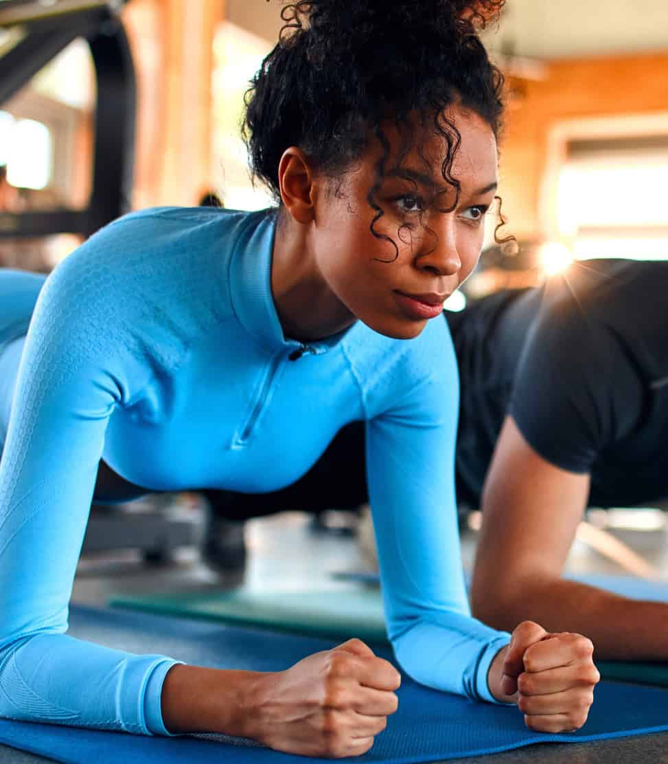 Optimized alt text for athletes performing core exercises at a sports medicine clinic, emphasizing rehabilitation, pain management, injury recovery, physical therapy, and sports performance.